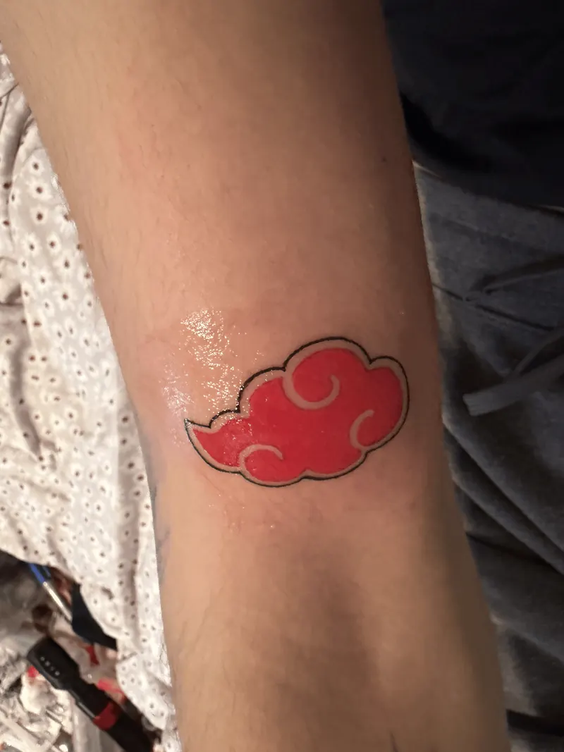 Bold red cloud tattoo with clean black outline